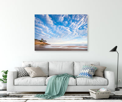 Coastal scene wall art canvas on the wall with a living room couch