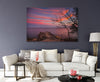 sunset with beautiful wispy clouds rocks trees and the ocean wall art canvas on a living room wall