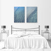 modern wall art prints of blue water ocean ripples on the wall in a bedroom