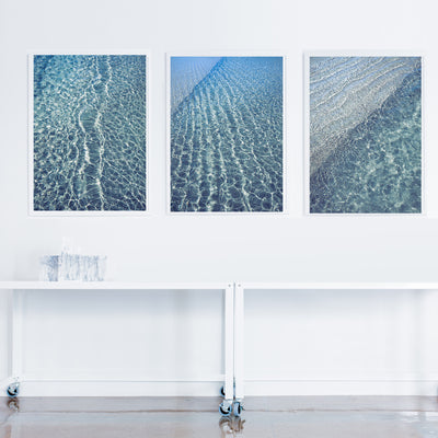 modern wall art triptych prints of blue water ocean ripples on the wall in a room