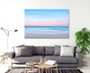 blue pink pastel coloured artistic wall art image of the ocean at sunset canvas print on the wall in a living room