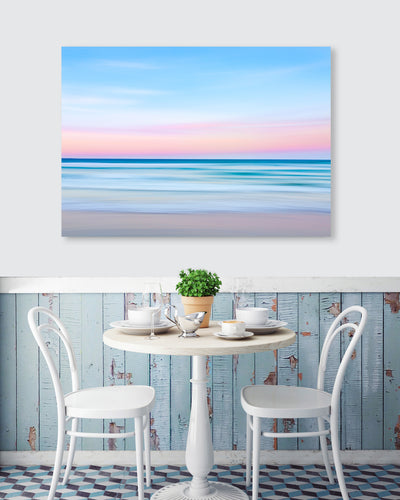 blue pink pastel coloured artistic wall art image of the ocean at sunset on the wall at a cafe