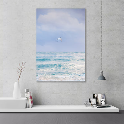 Interior Scene featuring wall art of a bird in flight over the ocean in purple teal and blue colours