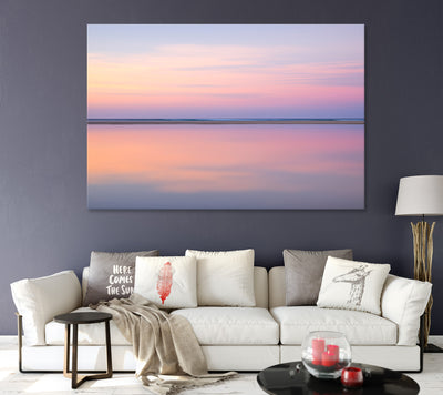 living room with dark purple walls featuring a framed wall art print of pastel pink abstract image of still calm waters at sunset on North Stradbroke Island also called Straddie