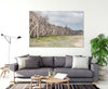 wall art featuring paperbark trees at Home Beach on North Stradbroke Island on the wall in a living room with a grey couch