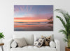 A lounge with A beautiful sunset wall art print of Adder Rock with a kayaker photographed at Stradbroke Island by Julie Sisco