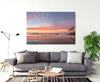A living room featuring A beautiful sunset wall art print of Adder Rock with a kayaker and fishermen photographed at Stradbroke Island by Julie Sisco