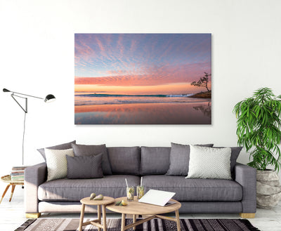 A living room featuring A beautiful sunset wall art print of Adder Rock with a kayaker and fishermen photographed at Stradbroke Island by Julie Sisco
